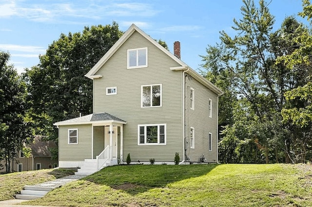 61 E Main, Merrimac, MA 01860 - view of front of home featuring a front lawn and a chimney