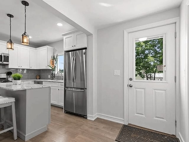 61 E Main, Merrimac, MA 01860 - kitchen with stainless steel appliances, plenty of natural light, tasteful backsplash, light wood-style flooring, and recessed lighting