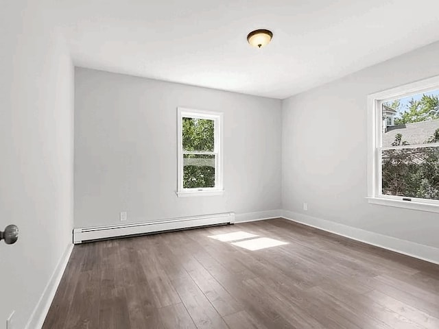 61 E Main, Merrimac, MA 01860 - spare room featuring a baseboard radiator, healthy amount of natural light, and dark wood-type flooring