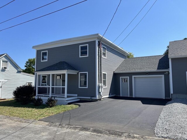 view of front of home with a front yard and a garage