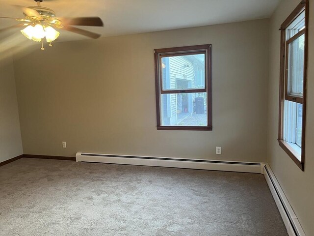 spare room with baseboard heating, ceiling fan, and carpet floors