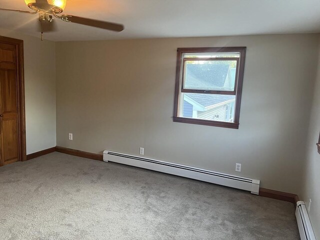 empty room with a baseboard radiator, ceiling fan, and carpet