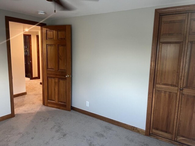 carpeted spare room featuring a baseboard radiator