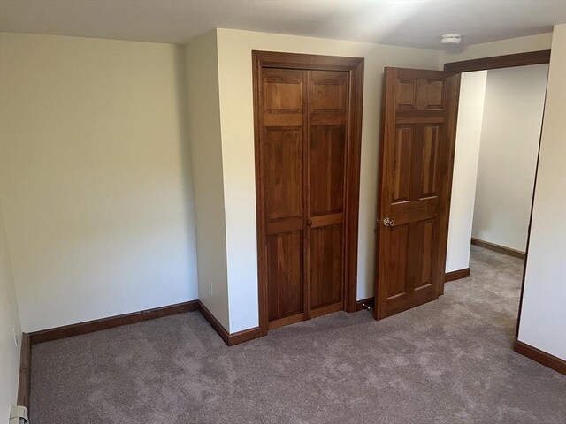 unfurnished bedroom featuring ceiling fan and light carpet