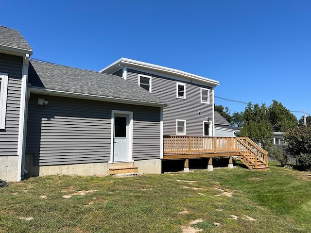 back of house with a yard and a deck