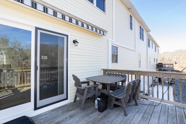 wooden deck featuring outdoor dining area