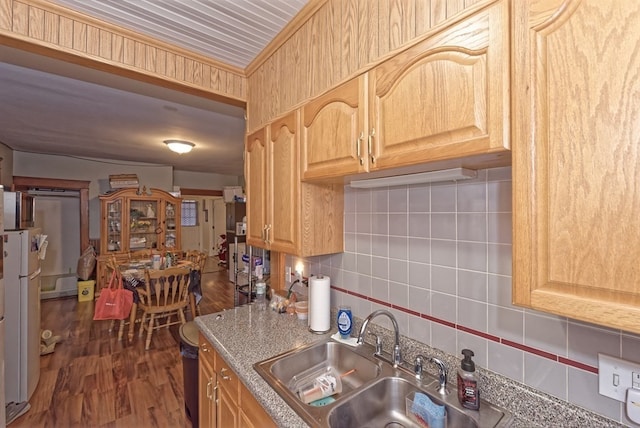 kitchen with decorative backsplash, light brown cabinetry, dark hardwood / wood-style floors, and sink