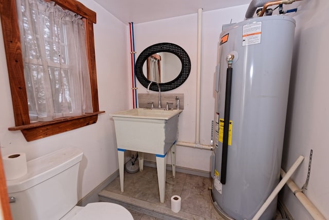 bathroom with tile patterned floors, toilet, and water heater