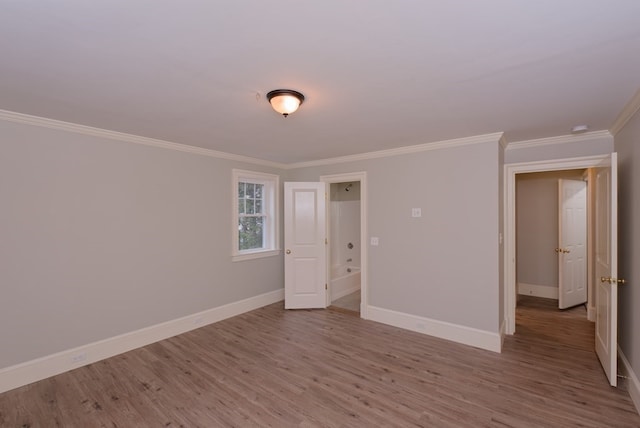 spare room with crown molding and light hardwood / wood-style floors