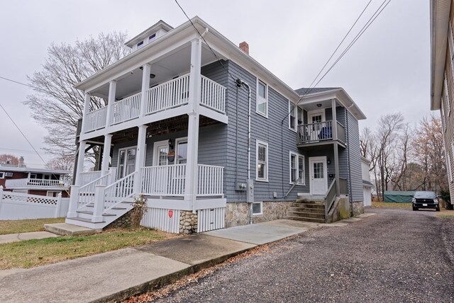 view of front of home featuring covered porch and a balcony