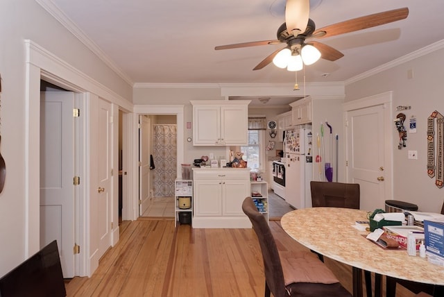 dining space with ceiling fan, ornamental molding, and light hardwood / wood-style flooring