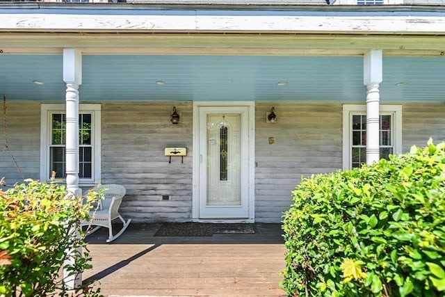 view of exterior entry with a porch