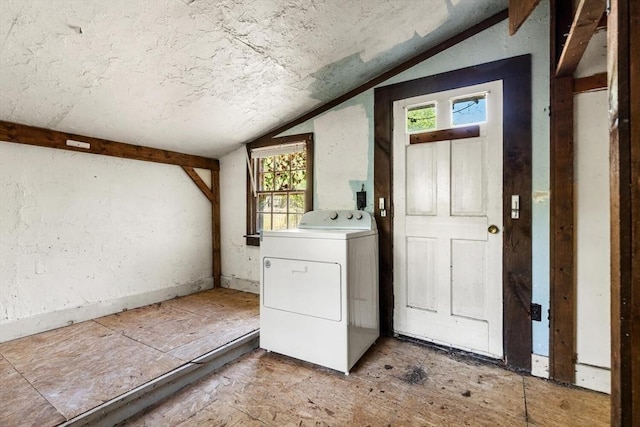 laundry room featuring washer / clothes dryer, a textured ceiling, and plenty of natural light