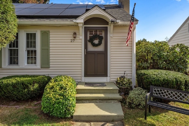 doorway to property featuring solar panels