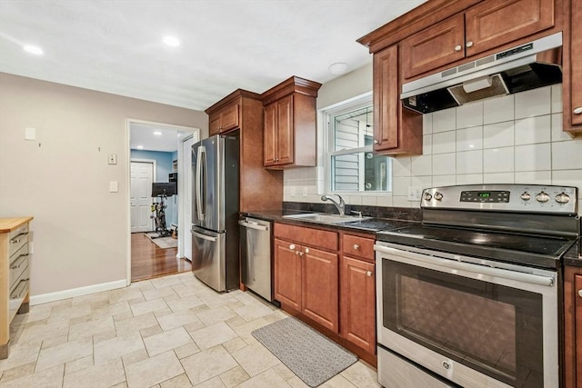 70 Donna Rd, Framingham, MA 01701 - kitchen with appliances with stainless steel finishes, under cabinet range hood, backsplash, recessed lighting, and brown cabinets