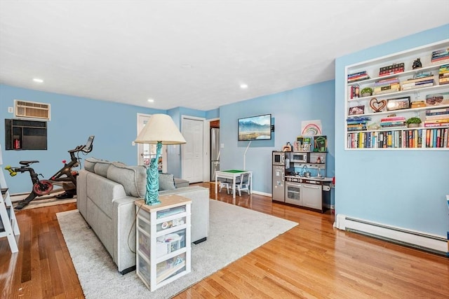 70 Donna Rd, Framingham, MA 01701 - living room featuring a baseboard radiator, wood finished floors, an AC wall unit, and recessed lighting