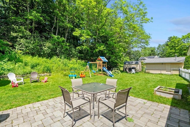 70 Donna Rd, Framingham, MA 01701 - view of patio / terrace featuring outdoor dining area, a playground, and a shed