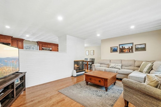70 Donna Rd, Framingham, MA 01701 - living room with light wood-style flooring, recessed lighting, and a multi sided fireplace