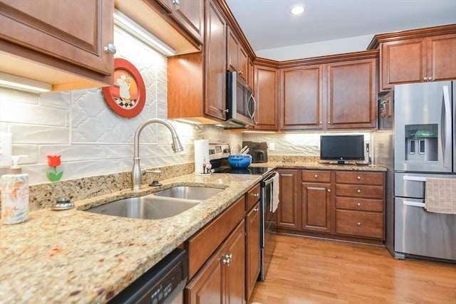 62 Abigail Way Unit 2003, Reading, MA 01867 - kitchen with appliances with stainless steel finishes, light wood finished floors, light stone countertops, decorative backsplash, and recessed lighting