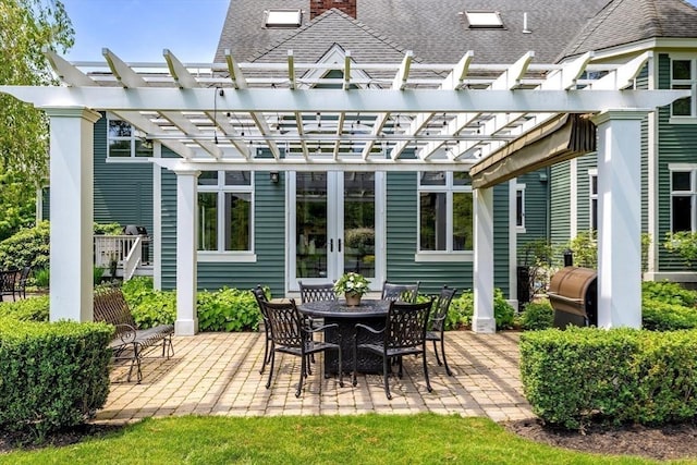 back of house with a pergola, a patio area, french doors, and a chimney