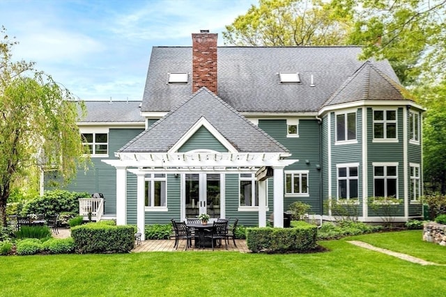 rear view of house with a lawn, a chimney, french doors, and a pergola