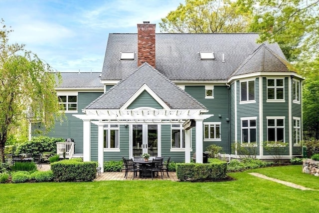 rear view of property featuring a pergola, a patio, a chimney, and a yard