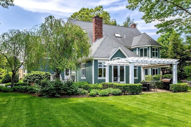 back of property with a yard, a pergola, and a patio