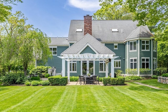 back of property featuring a pergola, a patio area, a chimney, and a yard