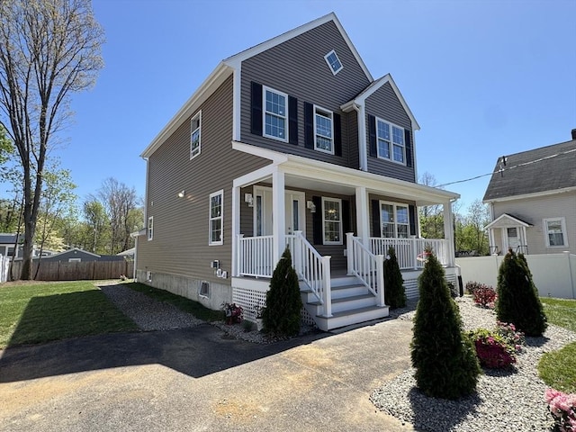 view of front of property with fence and covered porch
