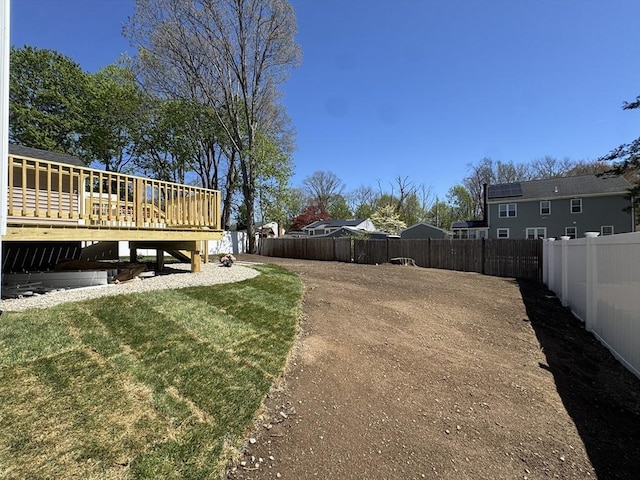 view of yard with a fenced backyard and a deck