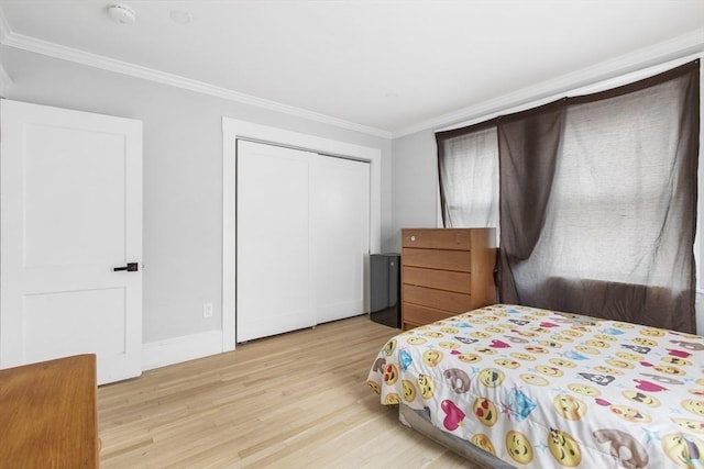 39 Pond St, Framingham, MA 01702 - bedroom with light wood-style flooring, crown molding, baseboards, and a closet