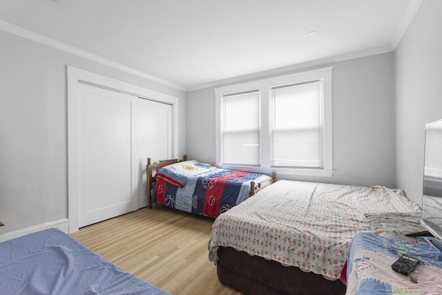 39 Pond St, Framingham, MA 01702 - bedroom with light wood-style floors, ornamental molding, and a closet