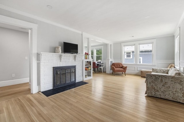 39 Pond St, Framingham, MA 01702 - living area featuring a fireplace, wood finished floors, and ornamental molding