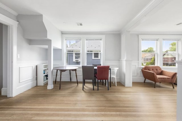 39 Pond St, Framingham, MA 01702 - dining space featuring wood finished floors, a wainscoted wall, ornamental molding, and a decorative wall