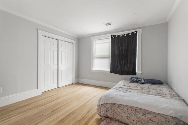 39 Pond St, Framingham, MA 01702 - bedroom featuring light wood-style flooring, baseboards, ornamental molding, and a closet