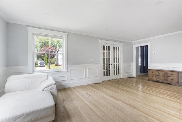 39 Pond St, Framingham, MA 01702 - living area with light wood finished floors, wainscoting, french doors, and ornamental molding