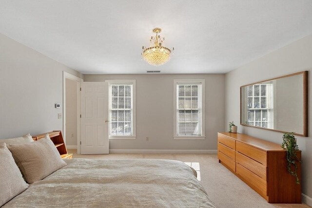 bedroom featuring visible vents, baseboards, and light colored carpet