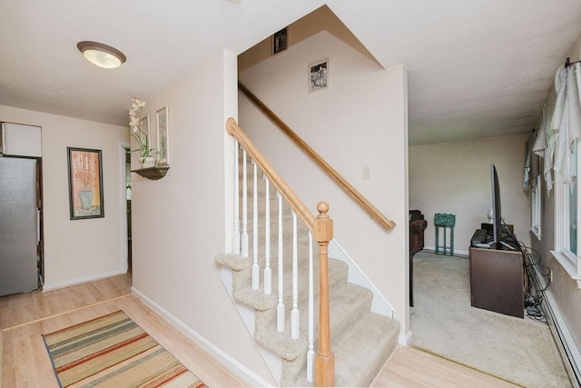 6 Gentry Ln, Taunton, MA 02780 - stairway featuring wood finished floors, baseboard heating, and baseboards
