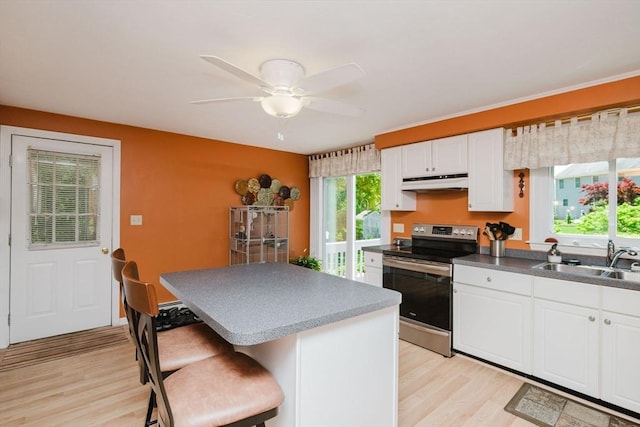 6 Gentry Ln, Taunton, MA 02780 - kitchen featuring electric range, under cabinet range hood, a sink, light wood finished floors, and a center island
