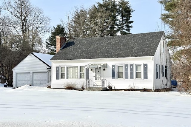 cape cod-style house with an outbuilding, central AC, a detached garage, and a chimney