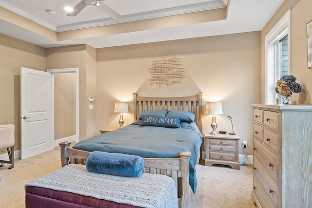 carpeted bedroom with crown molding, baseboards, a raised ceiling, and ceiling fan