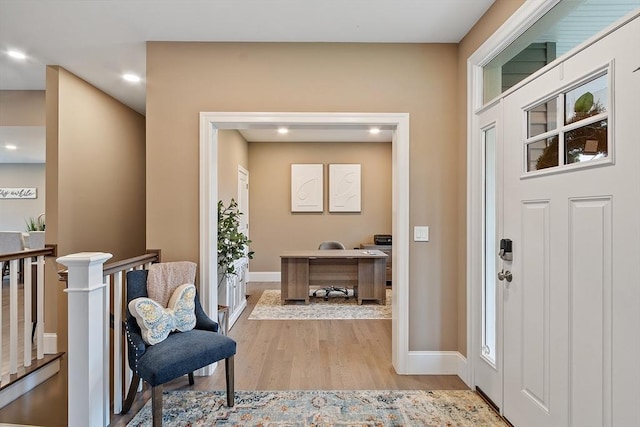 entrance foyer with wood finished floors, recessed lighting, and baseboards