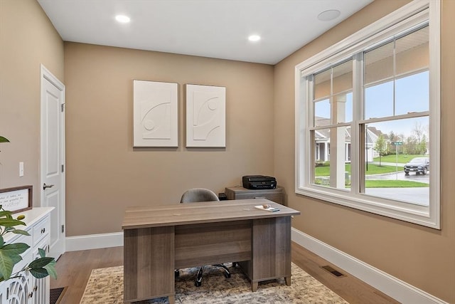 office area with baseboards, light wood-type flooring, and recessed lighting