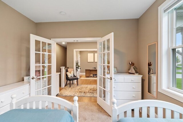 bedroom featuring french doors and carpet floors