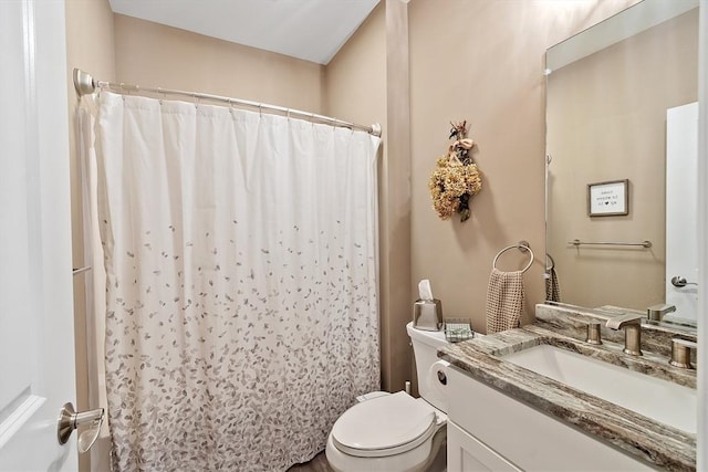 bathroom with vanity, toilet, and a shower with curtain