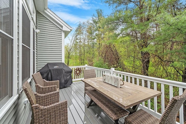 deck with grilling area and outdoor dining space