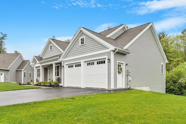 view of front of property with driveway, a front yard, a shingled roof, and an attached garage