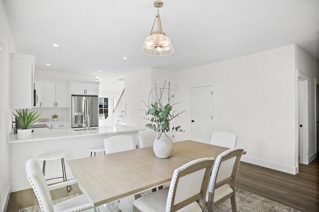 dining space with sink and dark wood-type flooring