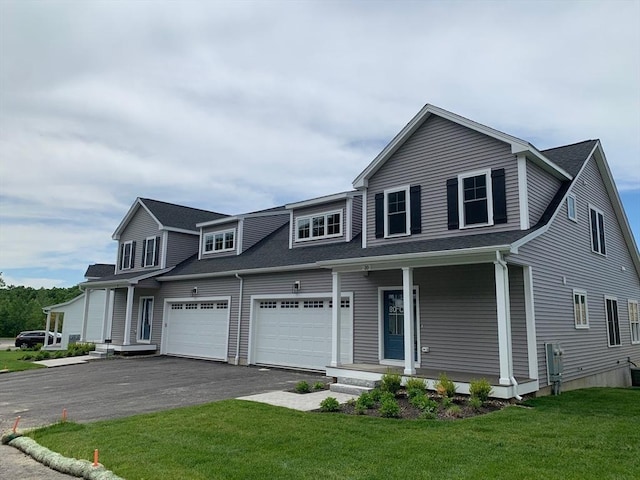 view of front of house featuring a garage and a front lawn