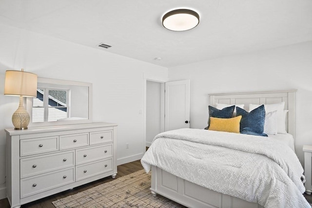 bedroom featuring dark hardwood / wood-style flooring